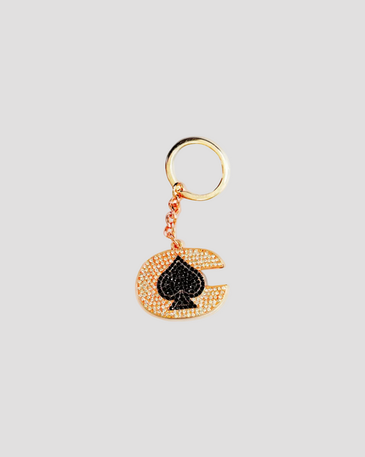 Gold earring with a blue gemstone on a white background